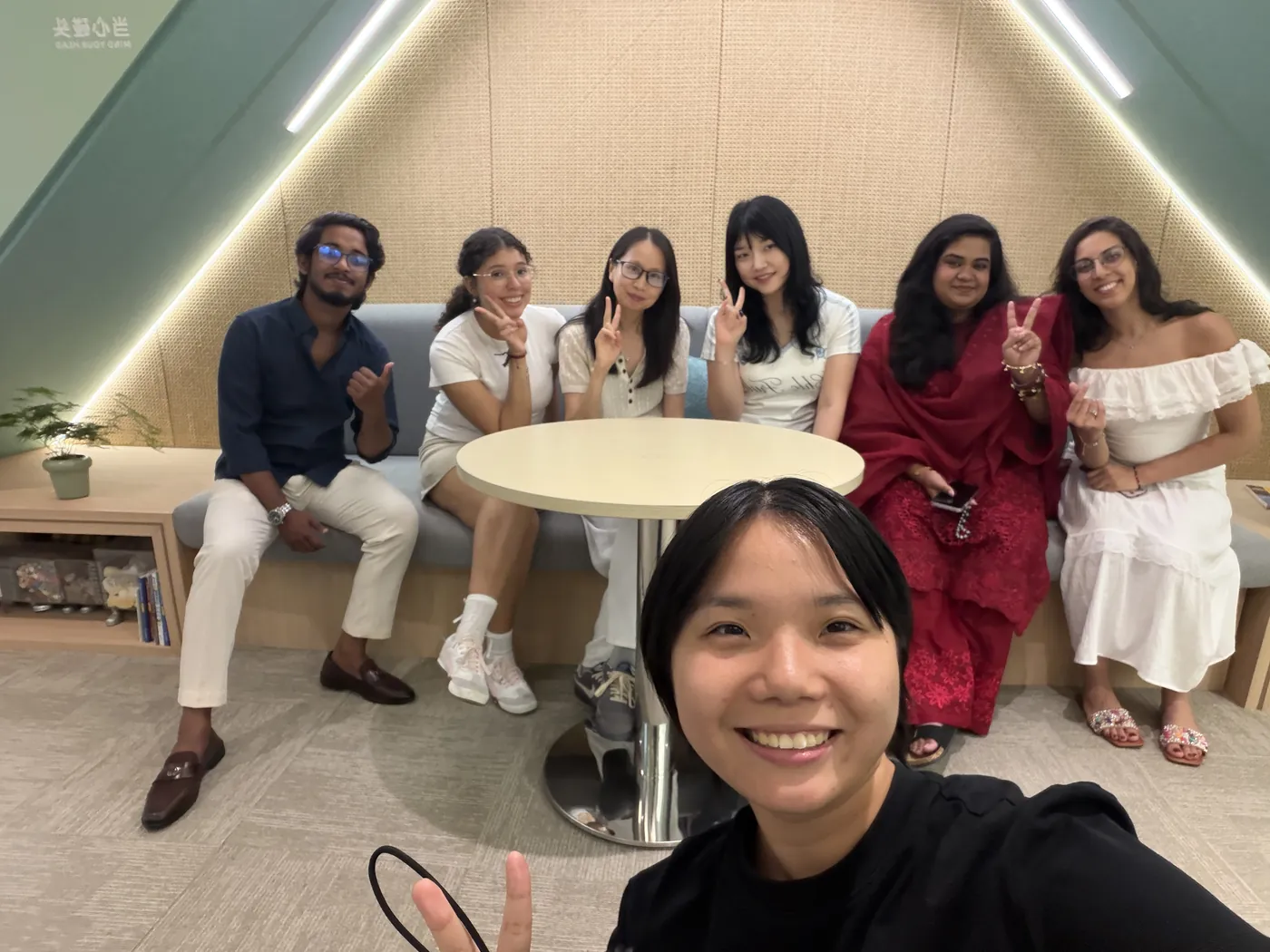 A selfie of a teacher with students in the lounge